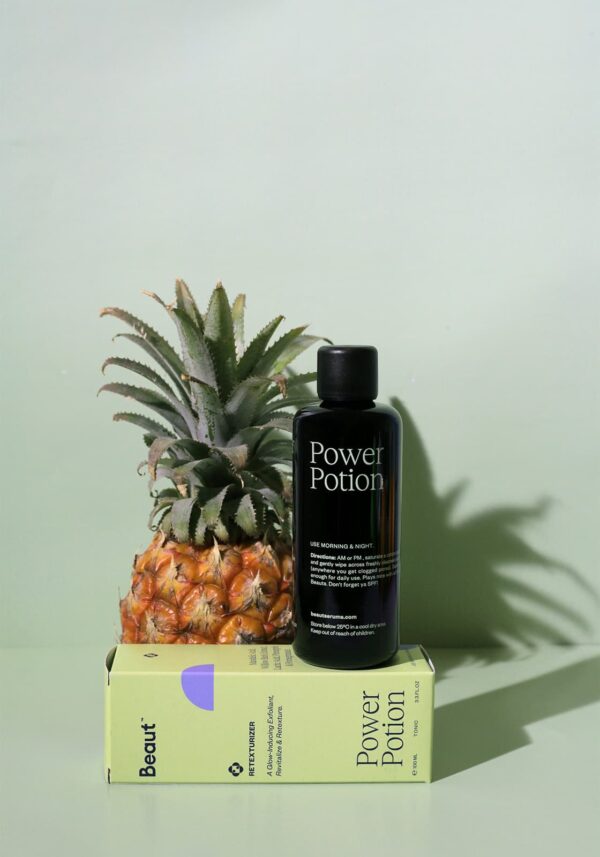 Power Potion by Beaut Serums in front of a pineapple